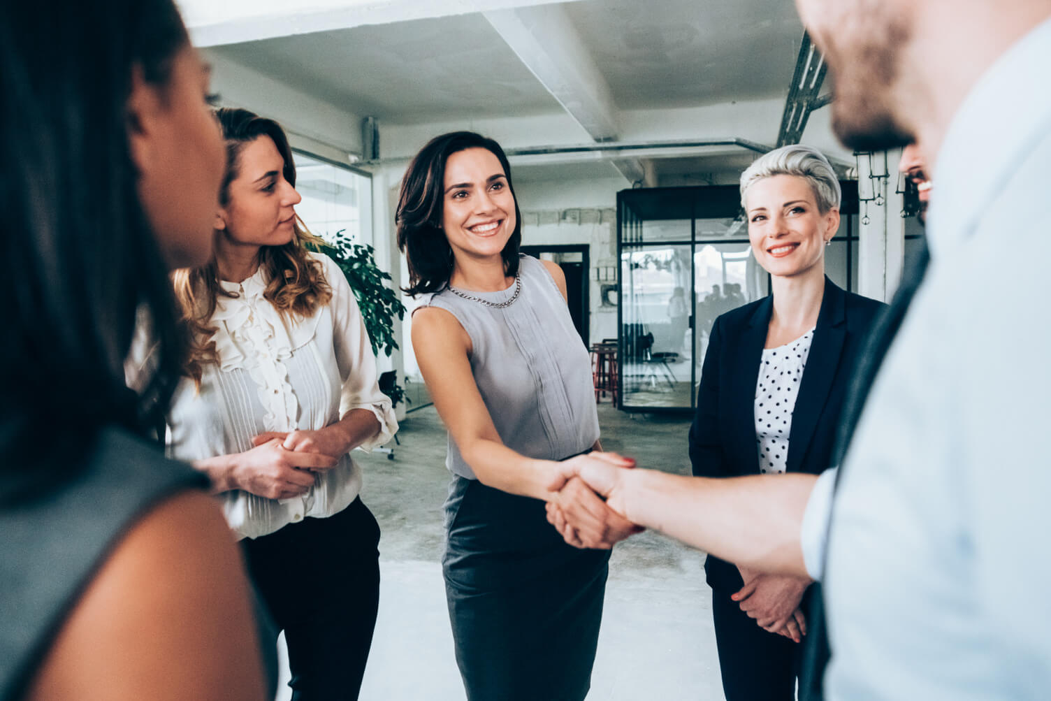 Two employees shaking hands