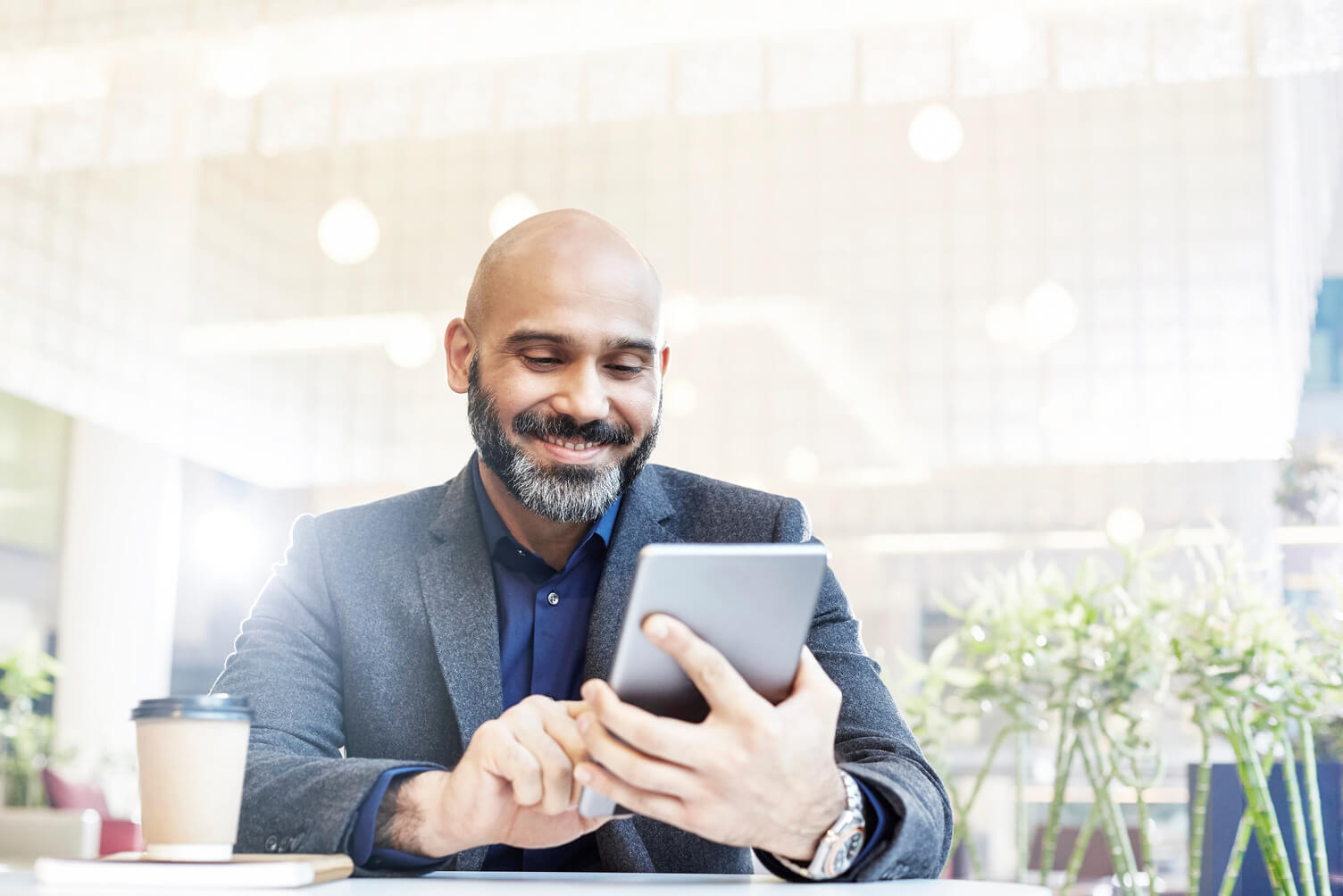 Man smiling while using his mobile device