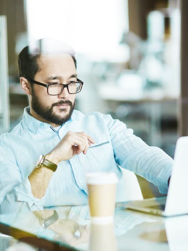 Man in an office assessing AML regulations