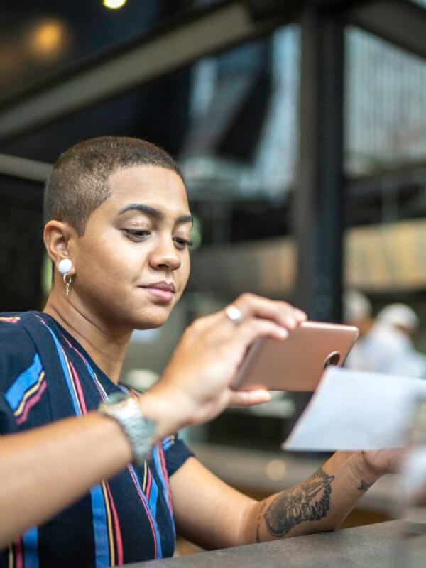 Woman taking a picture of a cheque