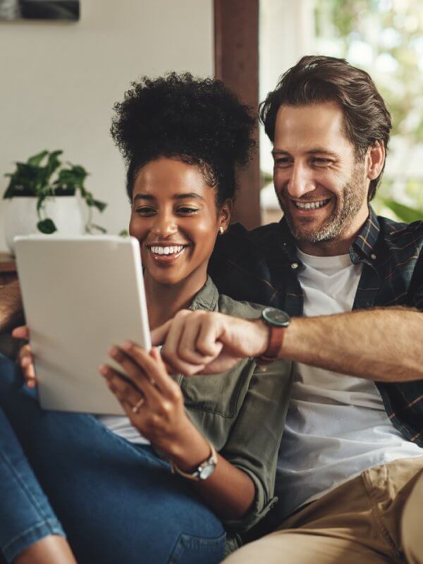 Couple at home applying for credit on a tablet